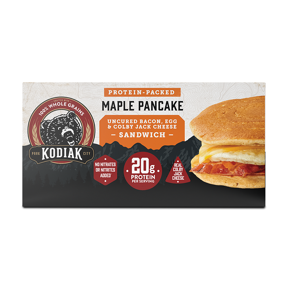 a box of protein-packed Kodiak Cakes Maple Pancake Uncured Bacon, Egg, and Colby Jack Cheese Sandwich